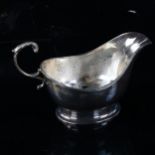 MAPPIN & WEBB - a George V silver sauce boat, pedestal form with reeded rim and a scrolled