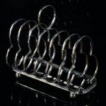 An Edwardian silver 7-bar clover toast rack, on bun feet, by James Deakin & Sons, hallmarks