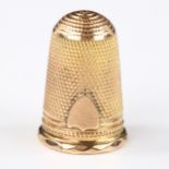 An Antique unmarked yellow metal thimble, with applied shield decoration, height 23.3mm, 4.5g