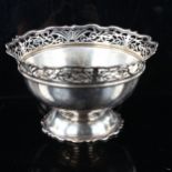 A large late Victorian silver pedestal fruit bowl, with pierced scalloped rim, by Sibray, Hall &