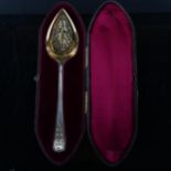 A cased Victorian silver Old English pattern serving spoon, beaded edge with pierced and gilded