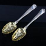 A pair of Danish silver berry spoons, bright-cut engraved and relief embossed floral decoration with