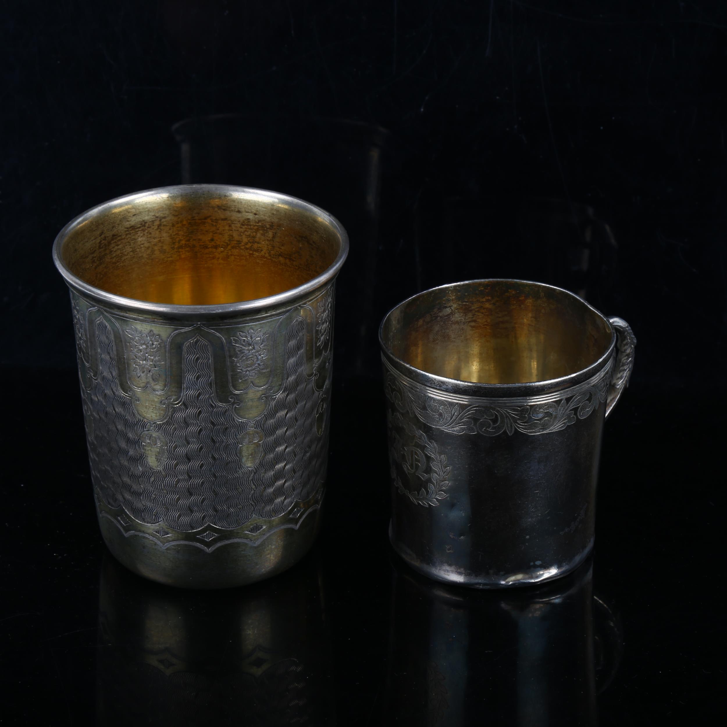 A Continental silver-gilt beaker, and a small unmarked white metal mug, largest height 8cm (2)