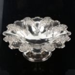 An Edwardian silver pedestal fruit bowl/tazza, with relief embossed floral and pierced lattice