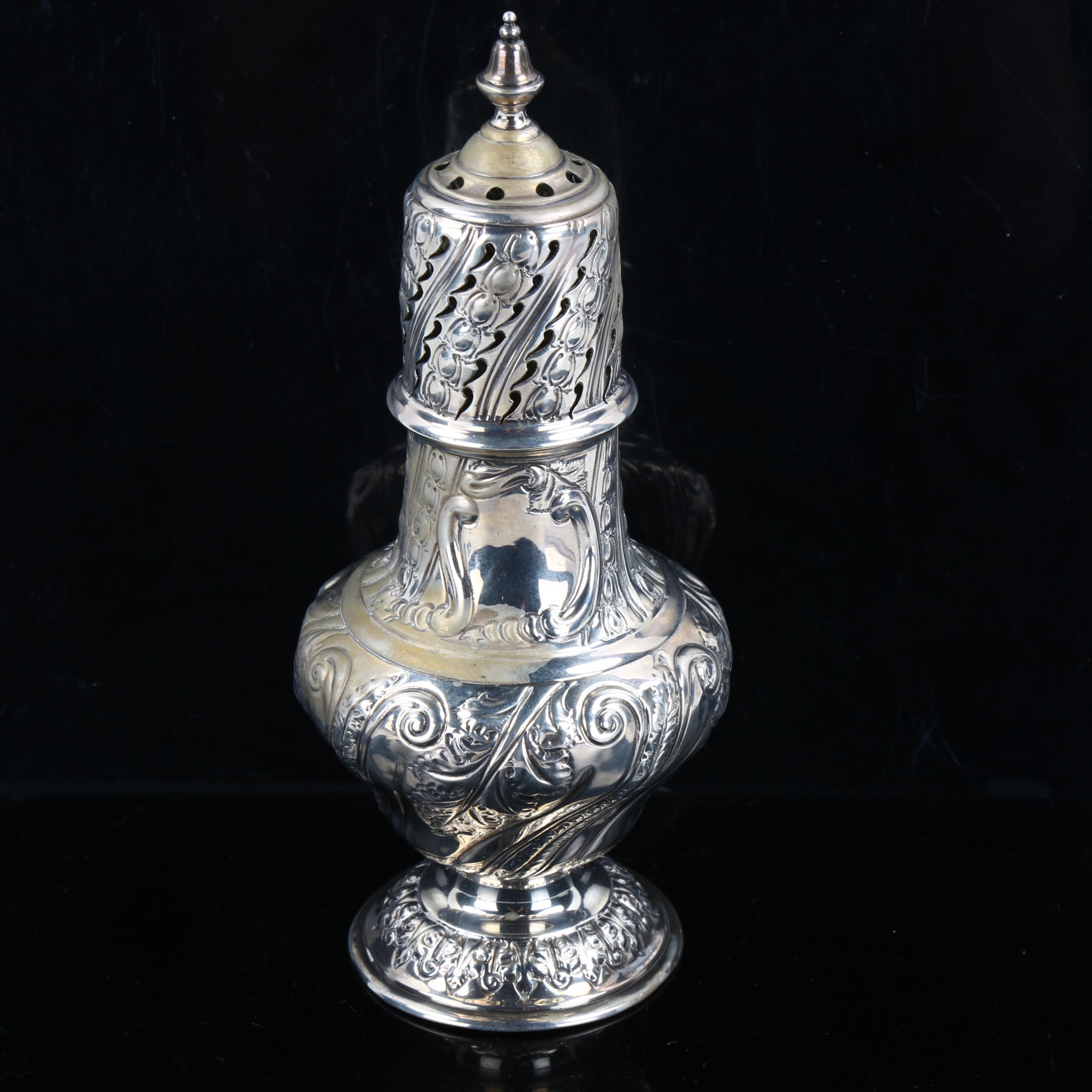 A Victorian silver baluster sugar caster, allover relief embossed foliate decoration, by Sibray,