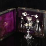 A leather-cased George V church communion set, comprising chalice, paten, wafer pyx, pair of glass