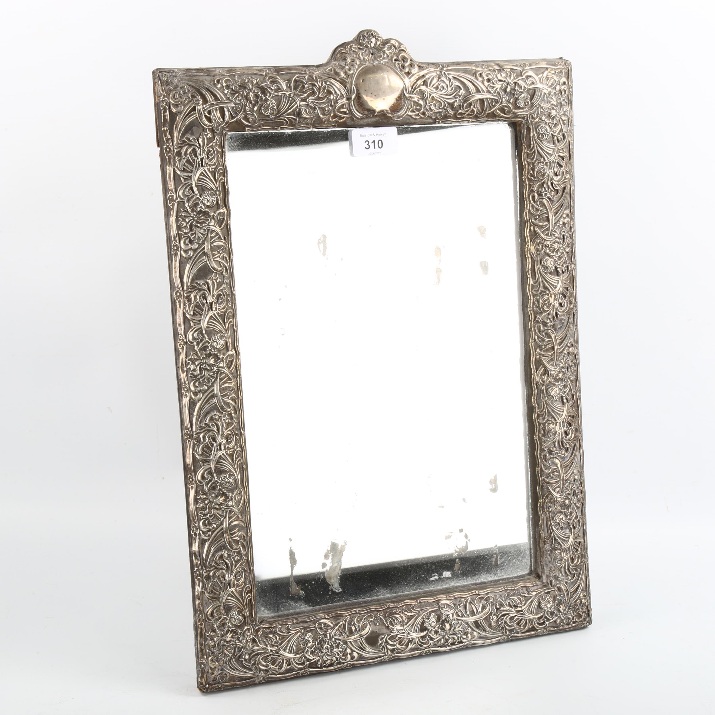 A large Edwardian silver-fronted rectangular dressing table strut mirror, embossed floral decoration