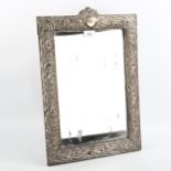 A large Edwardian silver-fronted rectangular dressing table strut mirror, embossed floral decoration