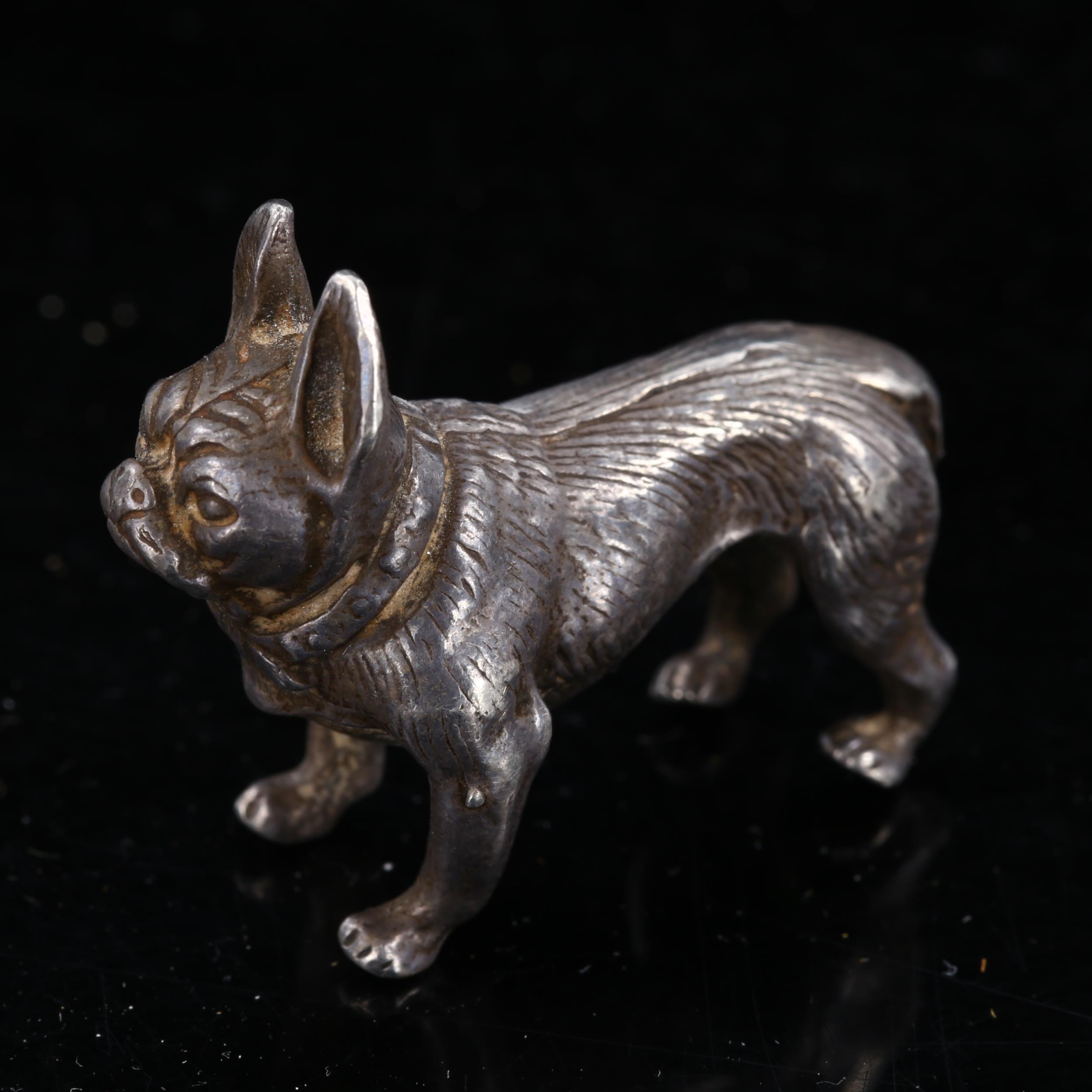 A miniature cast-silver French Bulldog model, indistinct hallmarks, length 3.5cm, 0.9oz No damage or