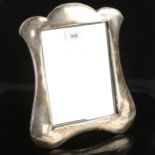An Edwardian silver-fronted dressing table strut mirror, shaped surround with original plate glass