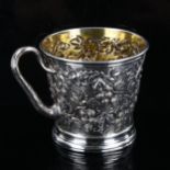 A Victorian silver grapevine mug, relief embossed and chased decoration with vine handle and gilt