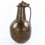A Middle Eastern handmade copper wine flagon and cover, engraved geometric decoration to the lid,