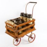 A rare Tri-ang toy milk cart, stained wood and metal, containing original tinplate milk churns and