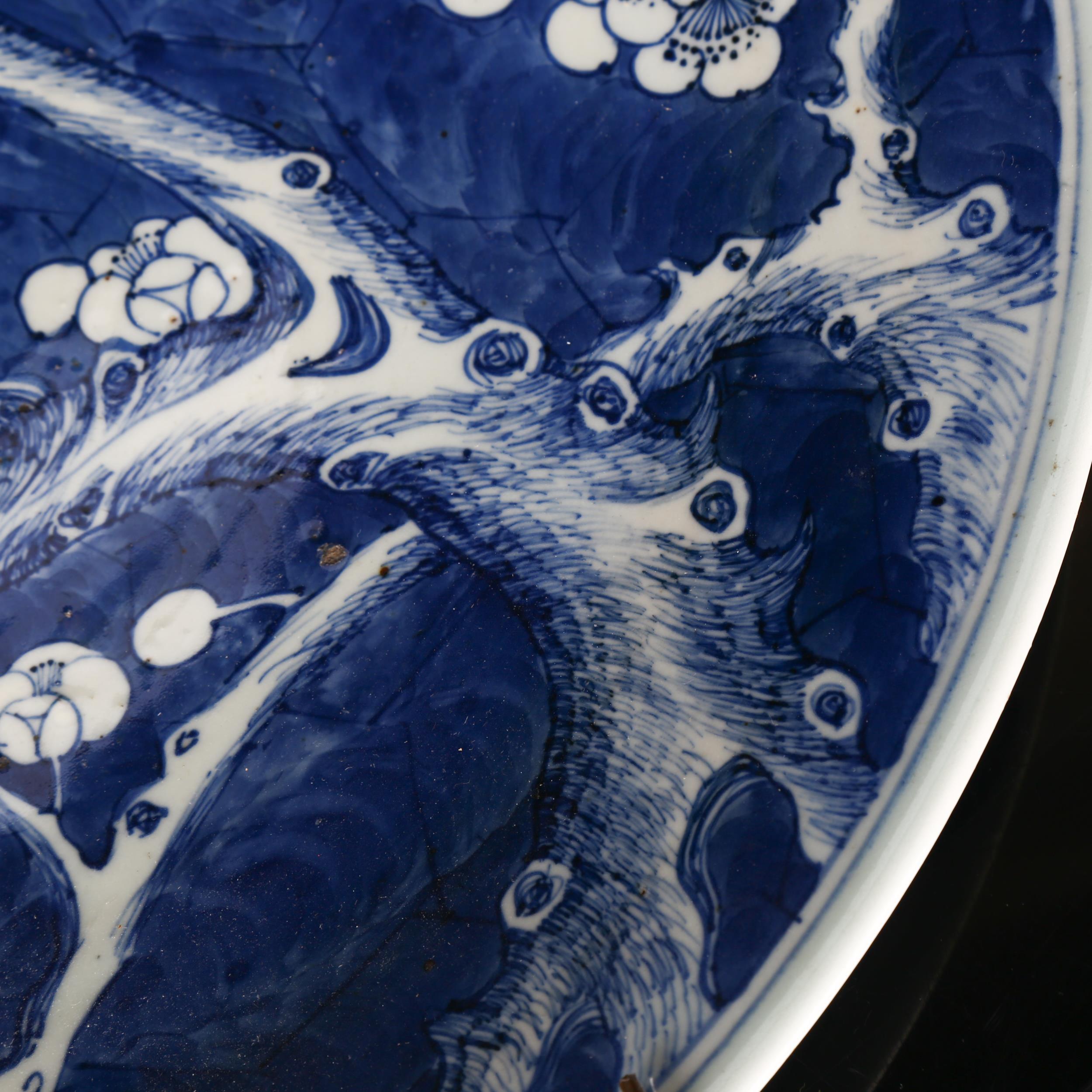 A large Chinese blue and white 'Prunus' charger, 19th century, decorated with underglaze blue, - Image 3 of 8