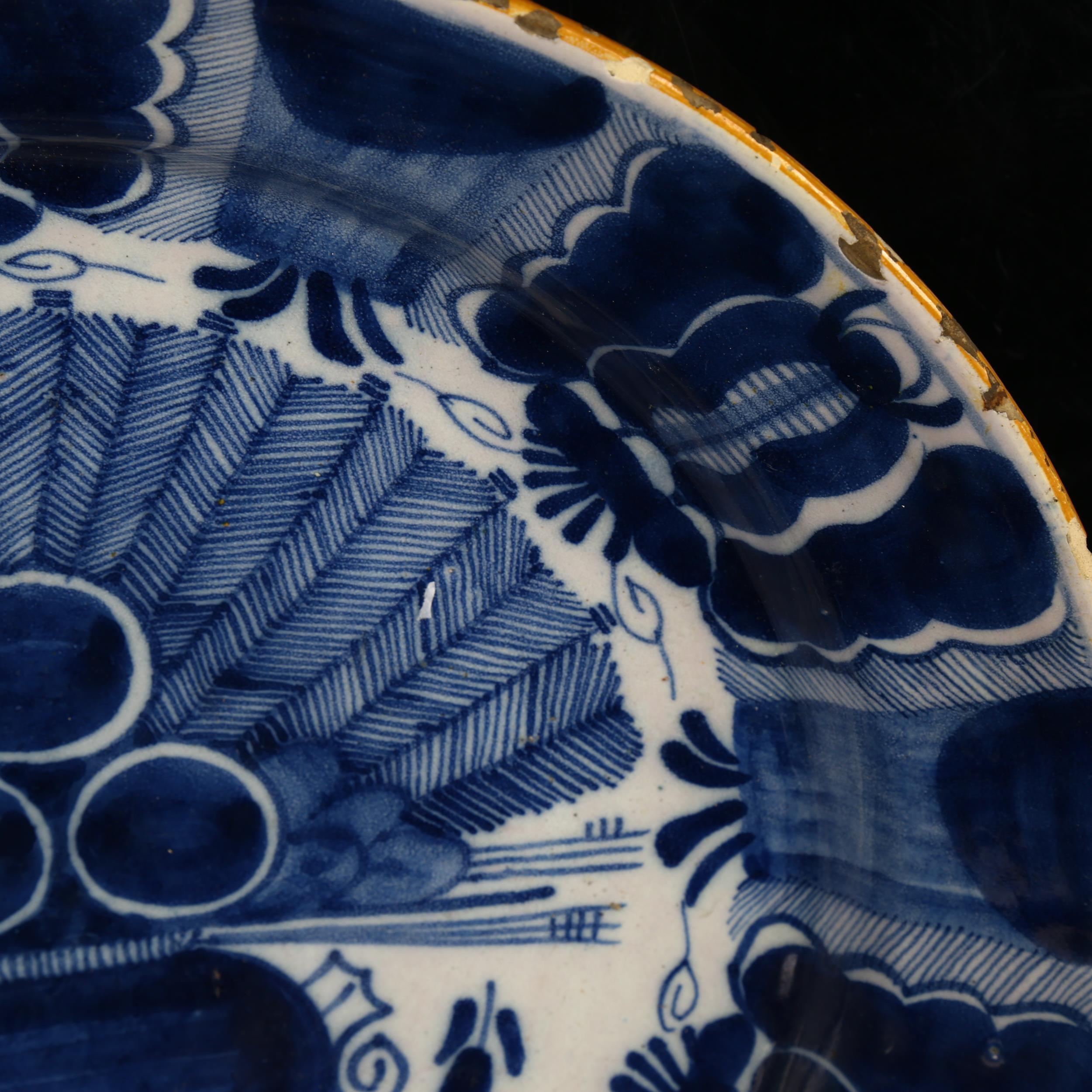 A graduated pair of 18th century Dutch Delft peacock pattern chargers, both marked, diameters 31cm - Image 4 of 19