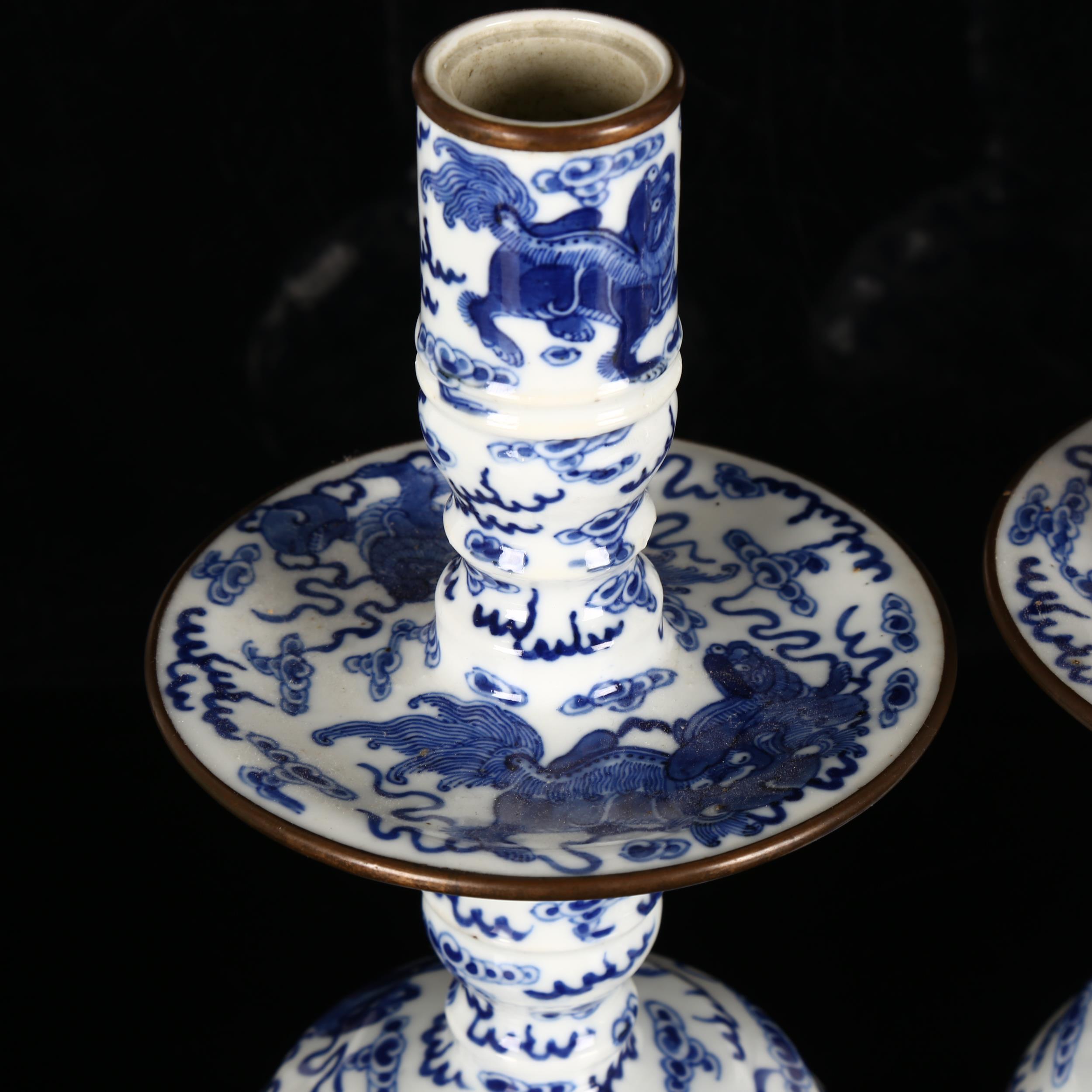 A pair of Chinese blue and white 'Dog of Fo' altar candlesticks, decorated in underglaze blue with - Image 11 of 12
