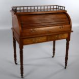 A Victorian walnut roll-top desk with tambour-front opening to reveal a pull-out leather-topped