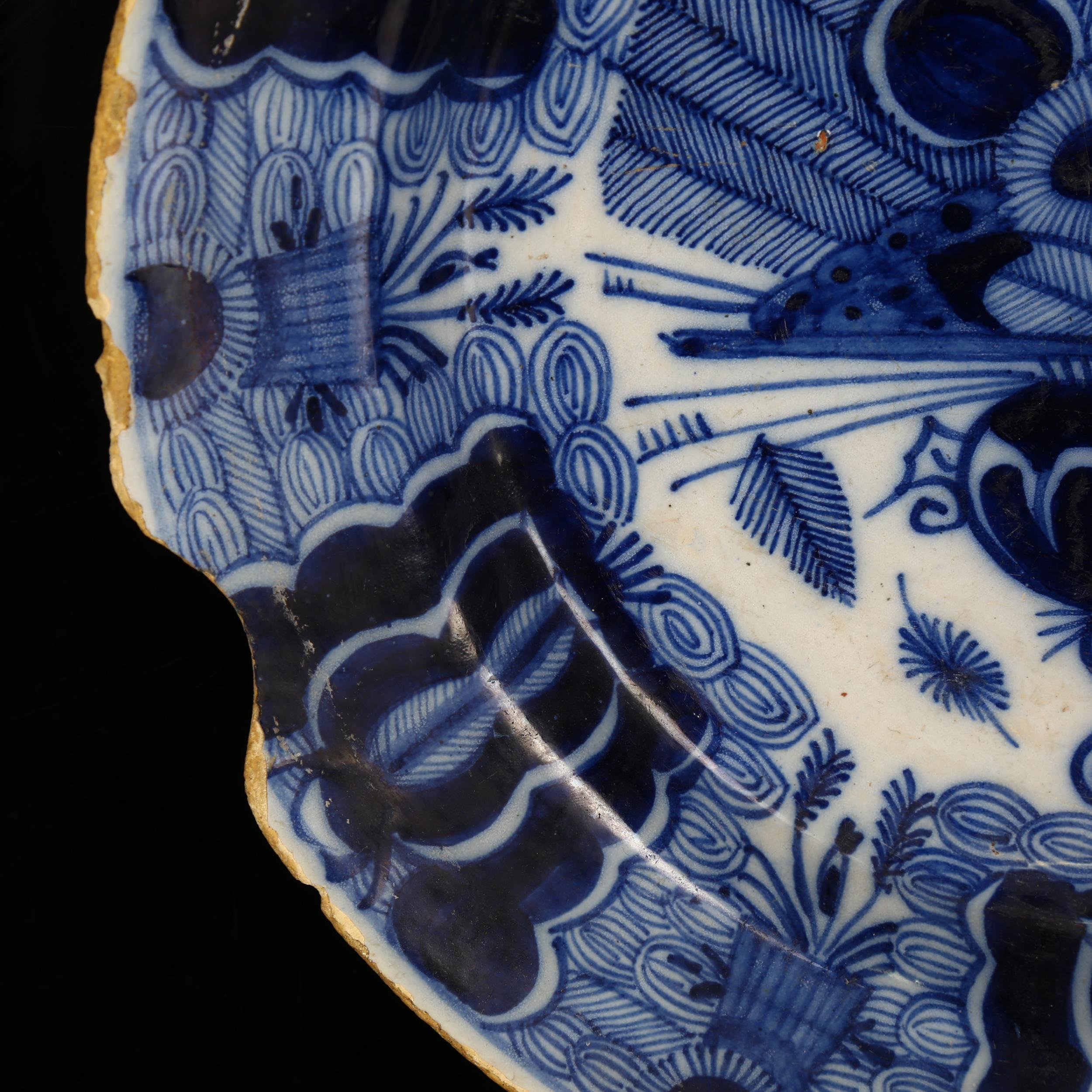 A graduated pair of 18th century Dutch Delft peacock pattern chargers, both marked, diameters 31cm - Image 12 of 19