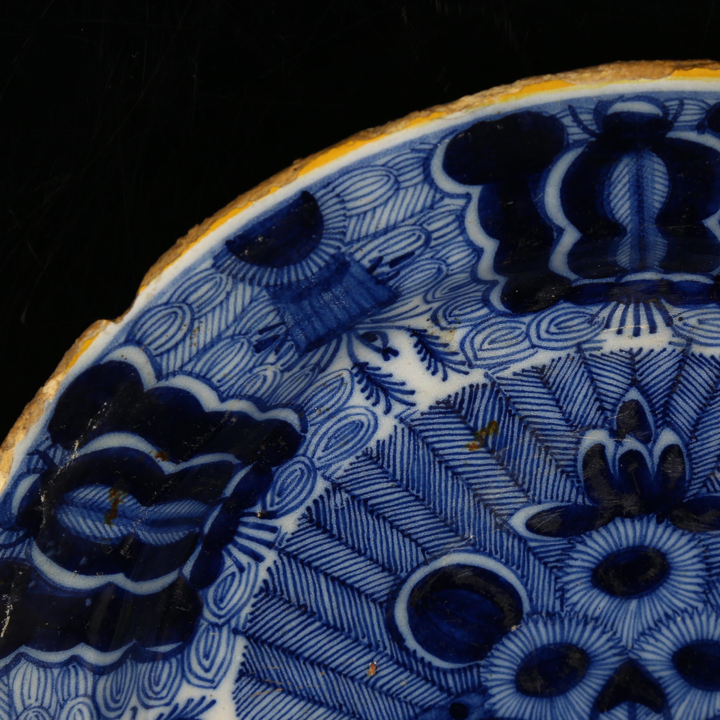 A graduated pair of 18th century Dutch Delft peacock pattern chargers, both marked, diameters 31cm - Image 13 of 19