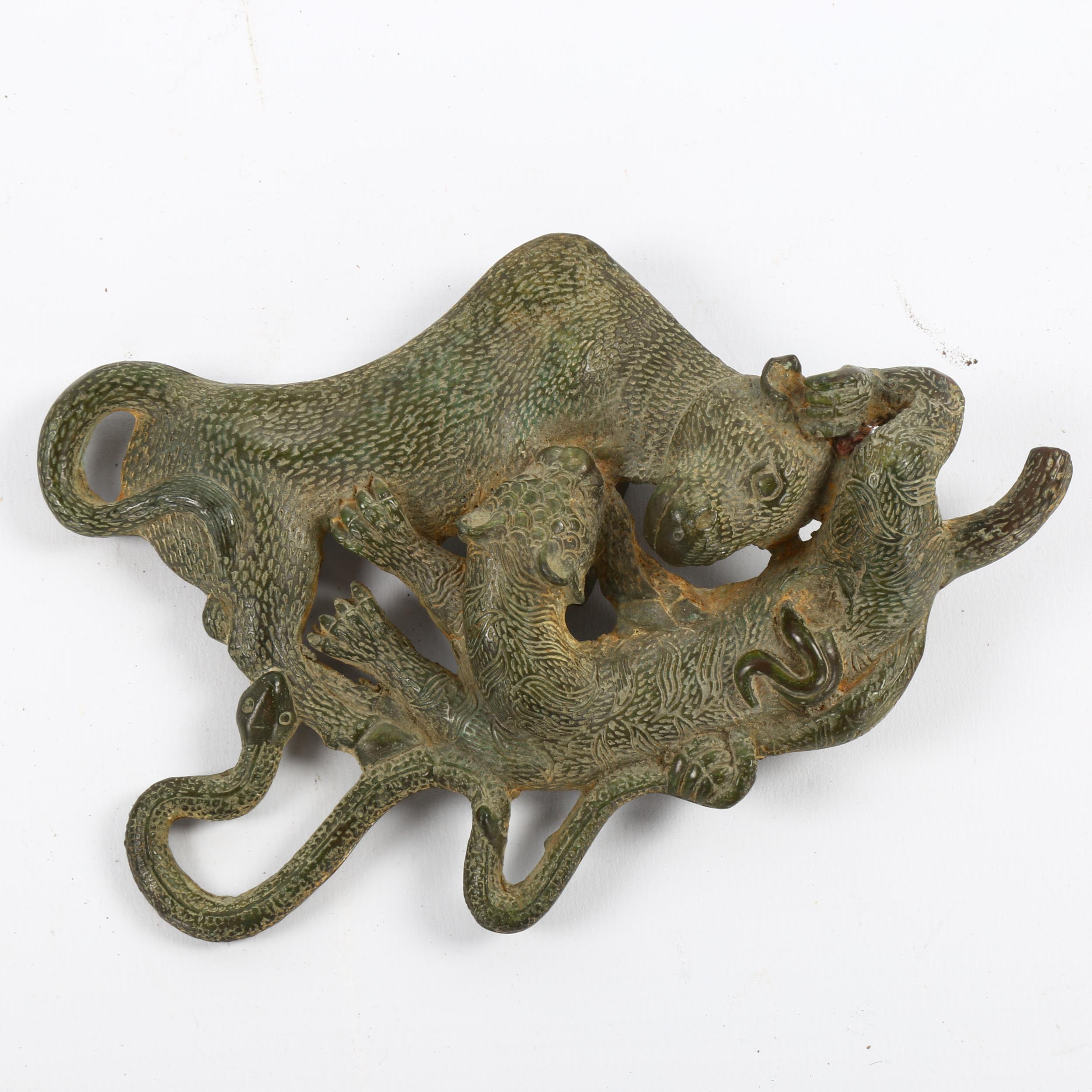 Indian cast verdigris bronze ornament in the form of a tiger and snake attacking a buffalo, length