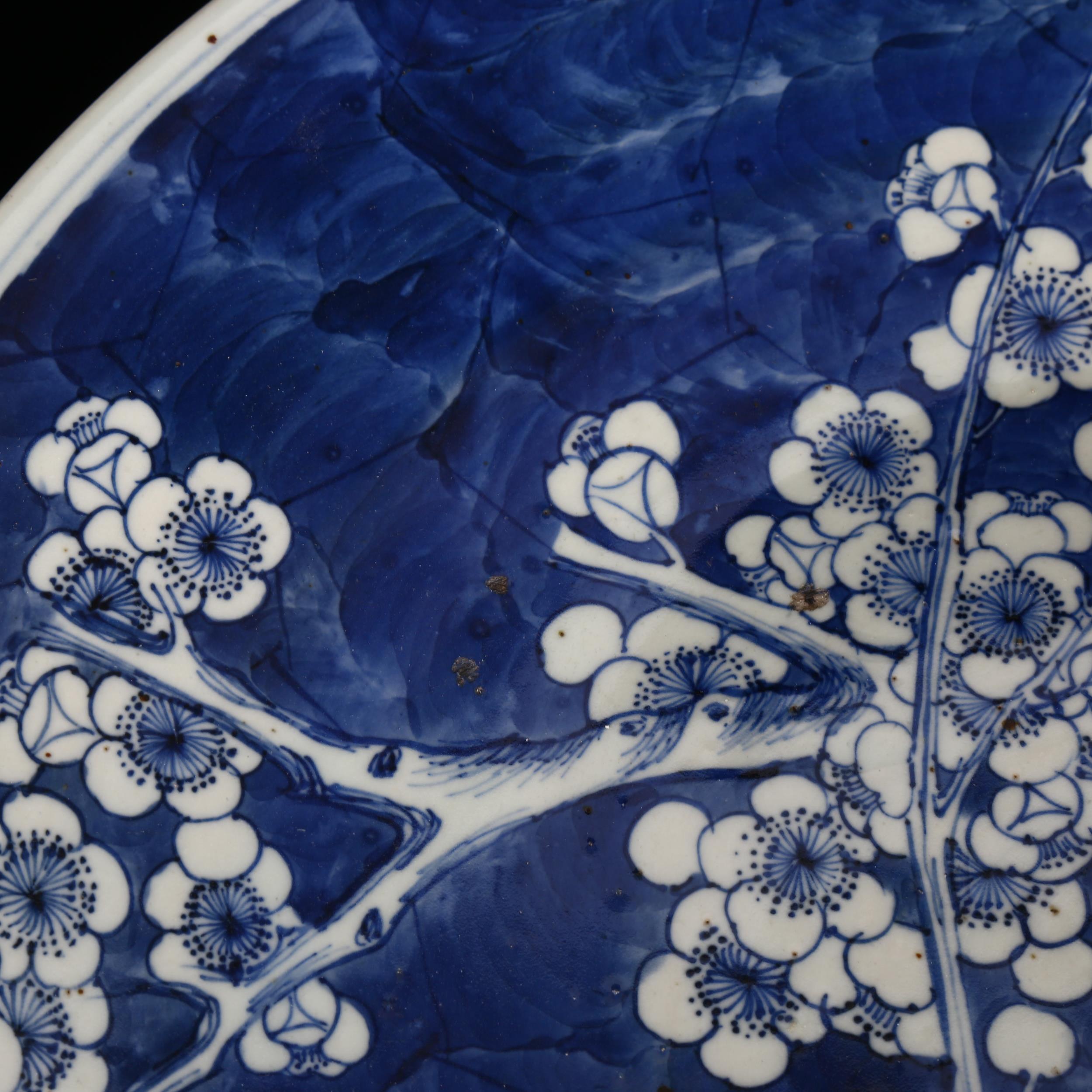 A large Chinese blue and white 'Prunus' charger, 19th century, decorated with underglaze blue, - Image 2 of 8