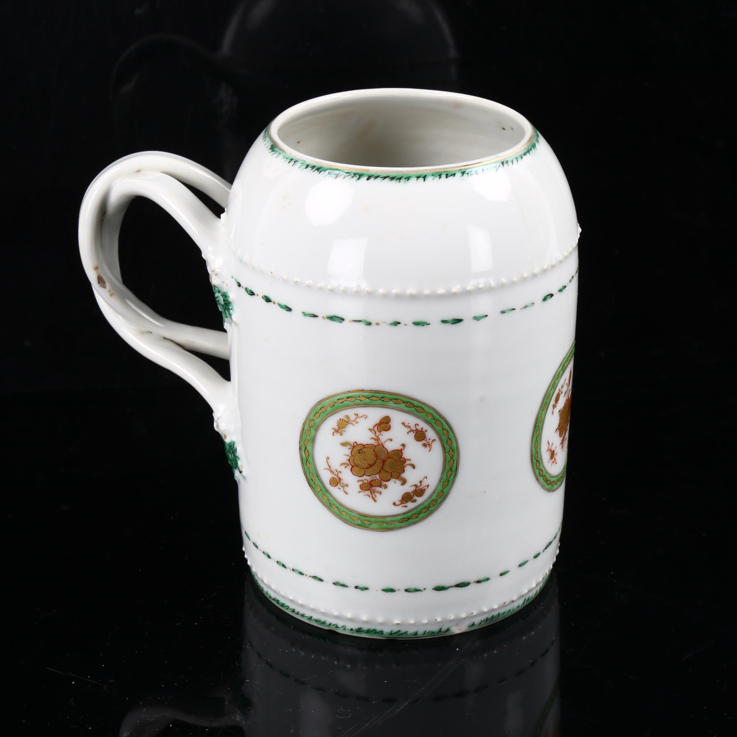 An 18th century Chinese export porcelain tankard, double entwined handles, with hand painted