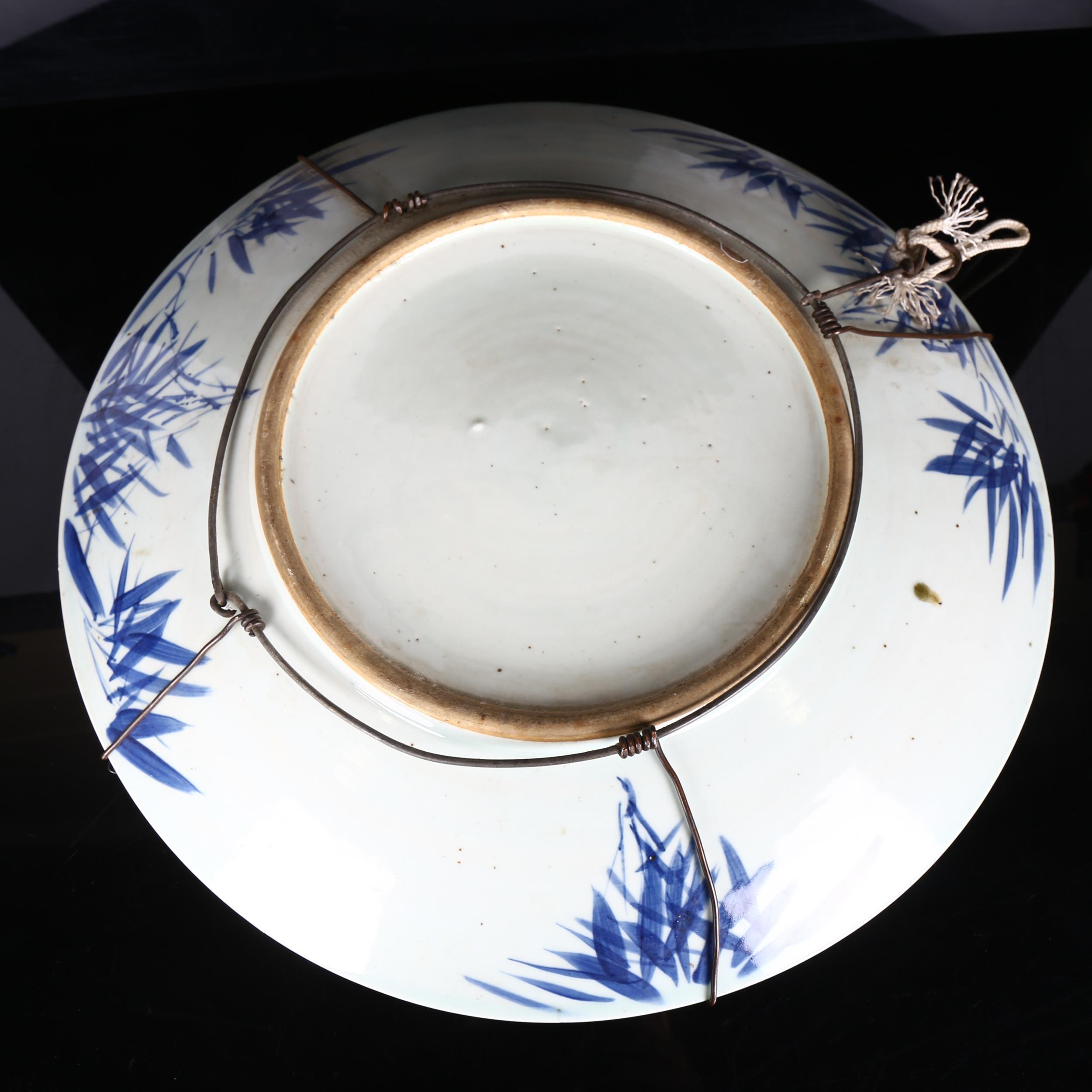 A large Chinese blue and white 'Prunus' charger, 19th century, decorated with underglaze blue, - Image 4 of 8