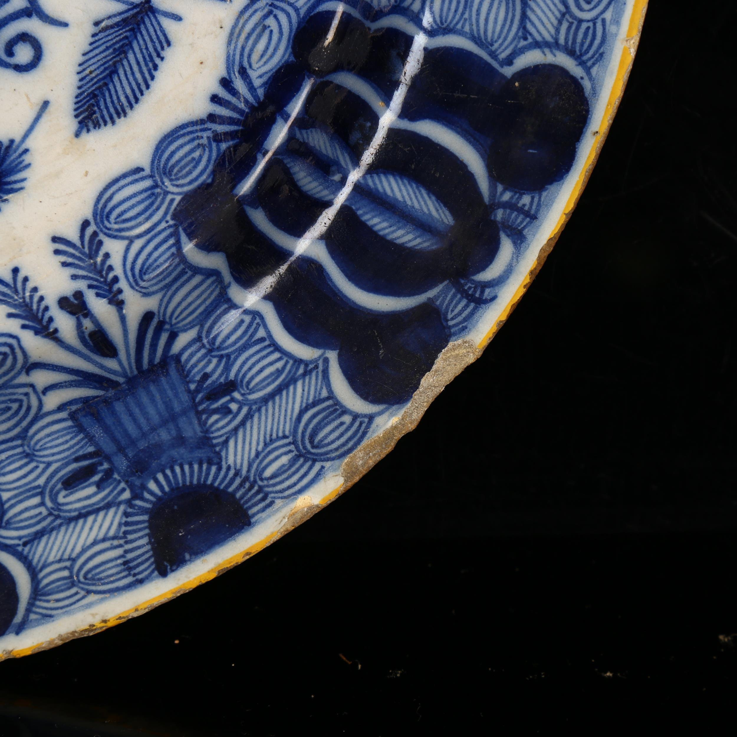 A graduated pair of 18th century Dutch Delft peacock pattern chargers, both marked, diameters 31cm - Image 15 of 19