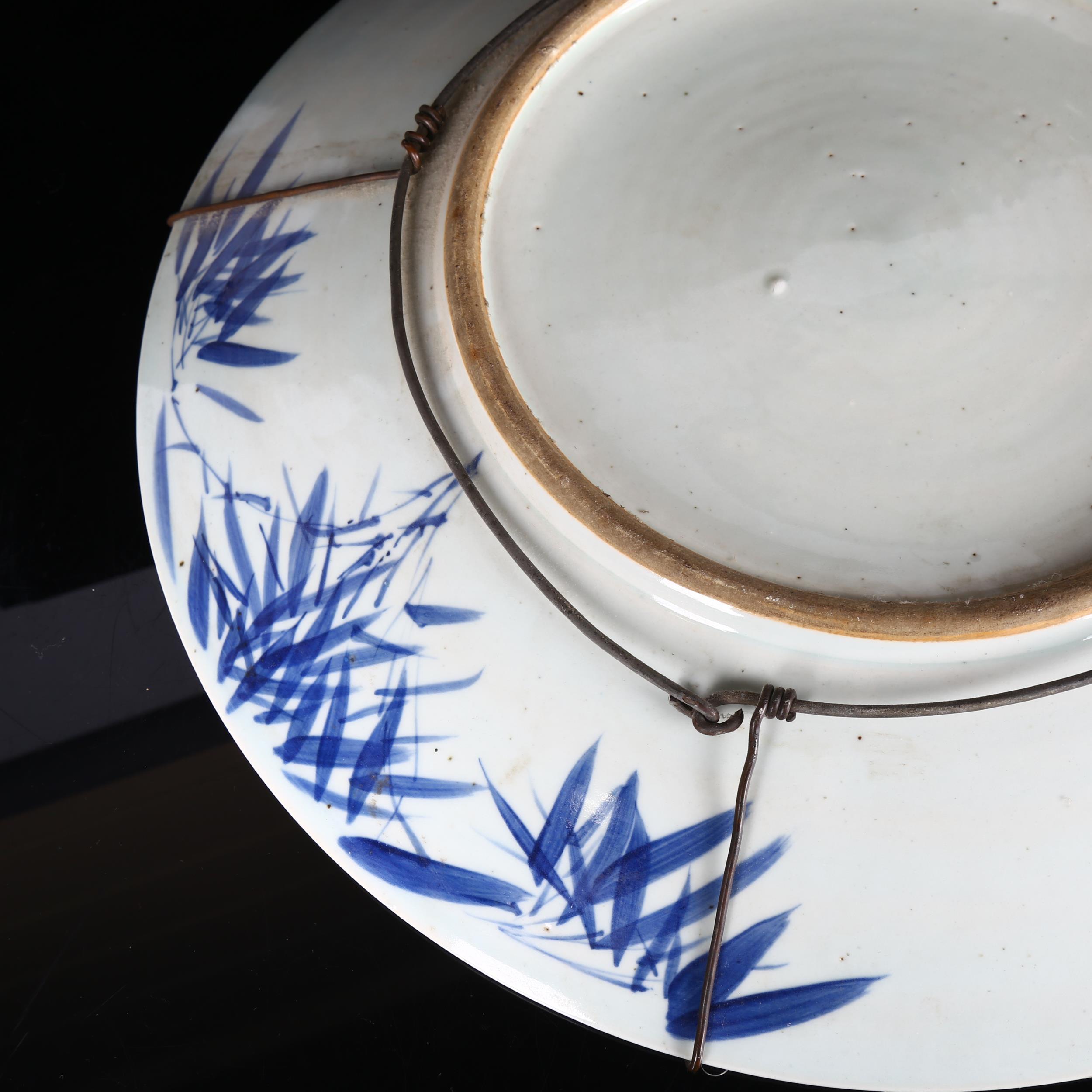 A large Chinese blue and white 'Prunus' charger, 19th century, decorated with underglaze blue, - Image 5 of 8