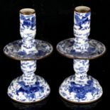 A pair of Chinese blue and white 'Dog of Fo' altar candlesticks, decorated in underglaze blue with
