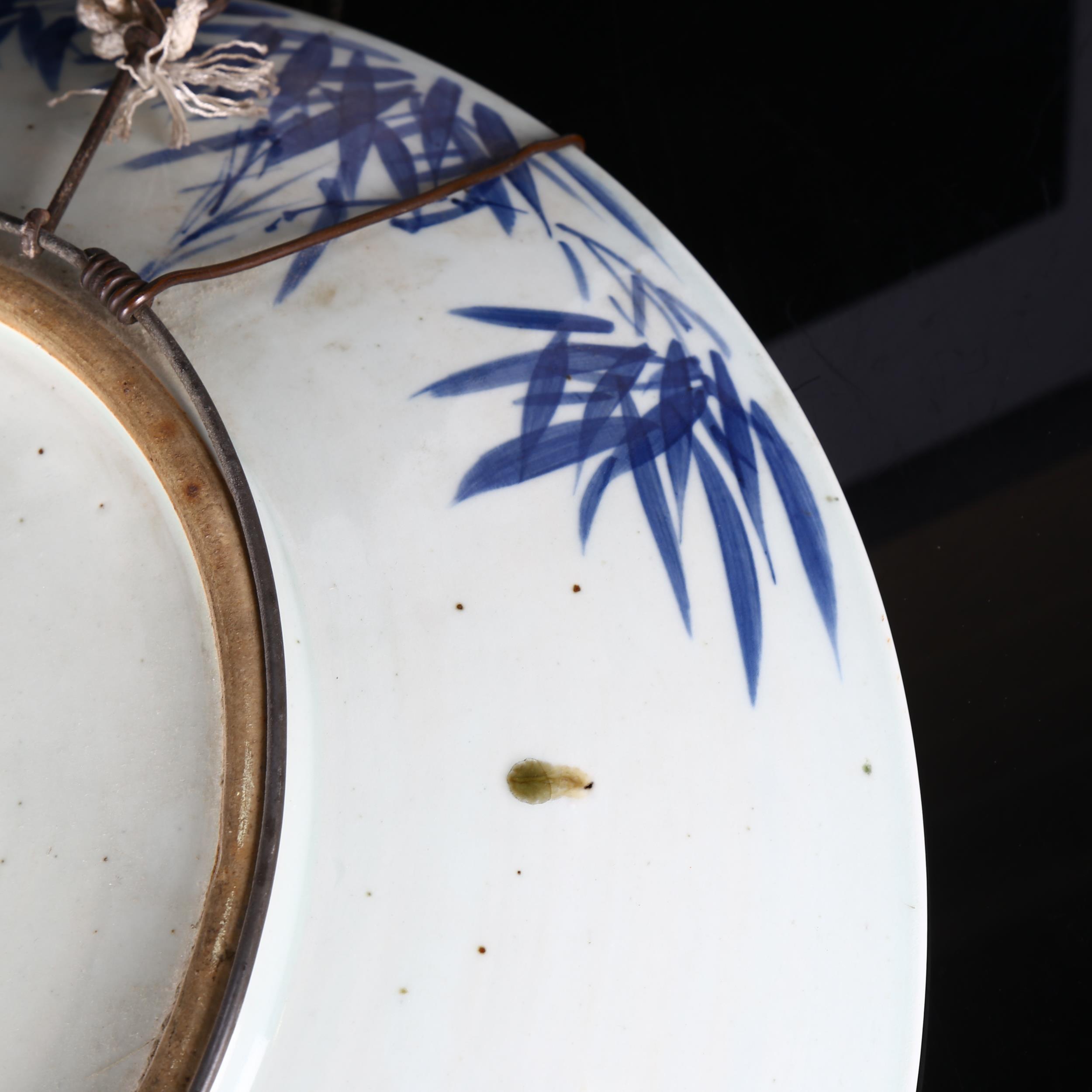 A large Chinese blue and white 'Prunus' charger, 19th century, decorated with underglaze blue, - Image 6 of 8