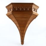 A large Victorian Gothic oak shelf bracket, with relief carved Gothic tracery frieze, height