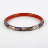 A Chinese cinnabar and cloisonne enamel slave bangle, band width 5.9mm, internal diameter 5.5cm,