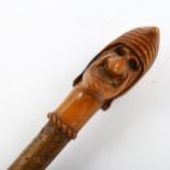 An 18th/19th century fruitwood Mrs Punch design walking stick, handle length 13cm, overall length