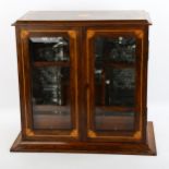 An Edwardian inlaid oak smoker's cabinet, with bevelled glass panelled doors, width 36cm, height