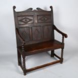 An 18th century oak settle of small size, with lozenge carved 5-panel back and bobbin turned