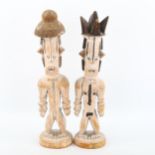A pair of African carved and painted wood Tribal figures, height 32cm