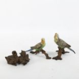 A pair of Austrian cold painted bronze parakeets, height 8cm, and bronze group of fledging chicks,