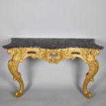 A 19th century French Rococo style console table, carved and scrolled giltwood frame with original