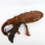 A Tribal witch doctor gourd, sinew-bound with animal and bone attachments, length 43cm