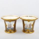 A pair of blue and gilt porcelain pots with flared rims and hand painted sea battle scene panels,