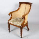 A 19th century mahogany framed Gillows style Bergere tub chair, with cane panel back, squab seat and