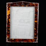 An Edwardian tortoiseshell photo frame, with unmarked silver mounts, overall height 26cm, internal