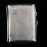 An Art Deco George VI curved silver cigarette case, allover engine turned decoration with gilt