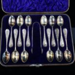 A cased set of 12 Victorian Aesthetic Movement silver teaspoons and pair of sugar tongs, with relief