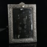 A large Edwardian silver-fronted rectangular dressing table strut mirror, embossed floral decoration