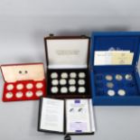 A collection of commemorative silver coins and medallions, including the Official Coin Collection in