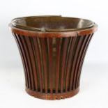A Georgian mahogany bucket, with lattice sides, brass liner and brass swing handle, diameter 34cm,