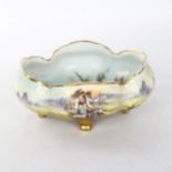 A Vienna porcelain bowl with hand painted decoration, depicting country women, on gilded feet, width