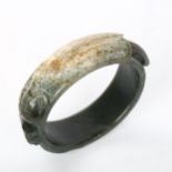 A relief carved jade bangle, internal diameter 7cm, width 2.5cm